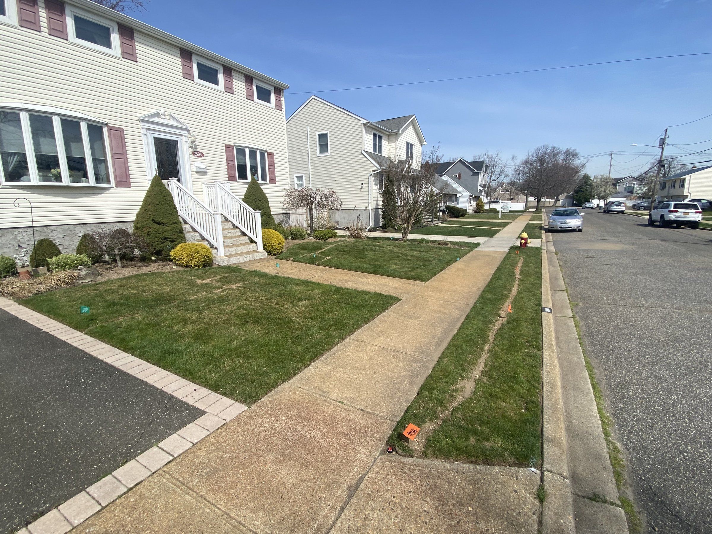 The sidewalk strip backfilled after the sprinkler line went in