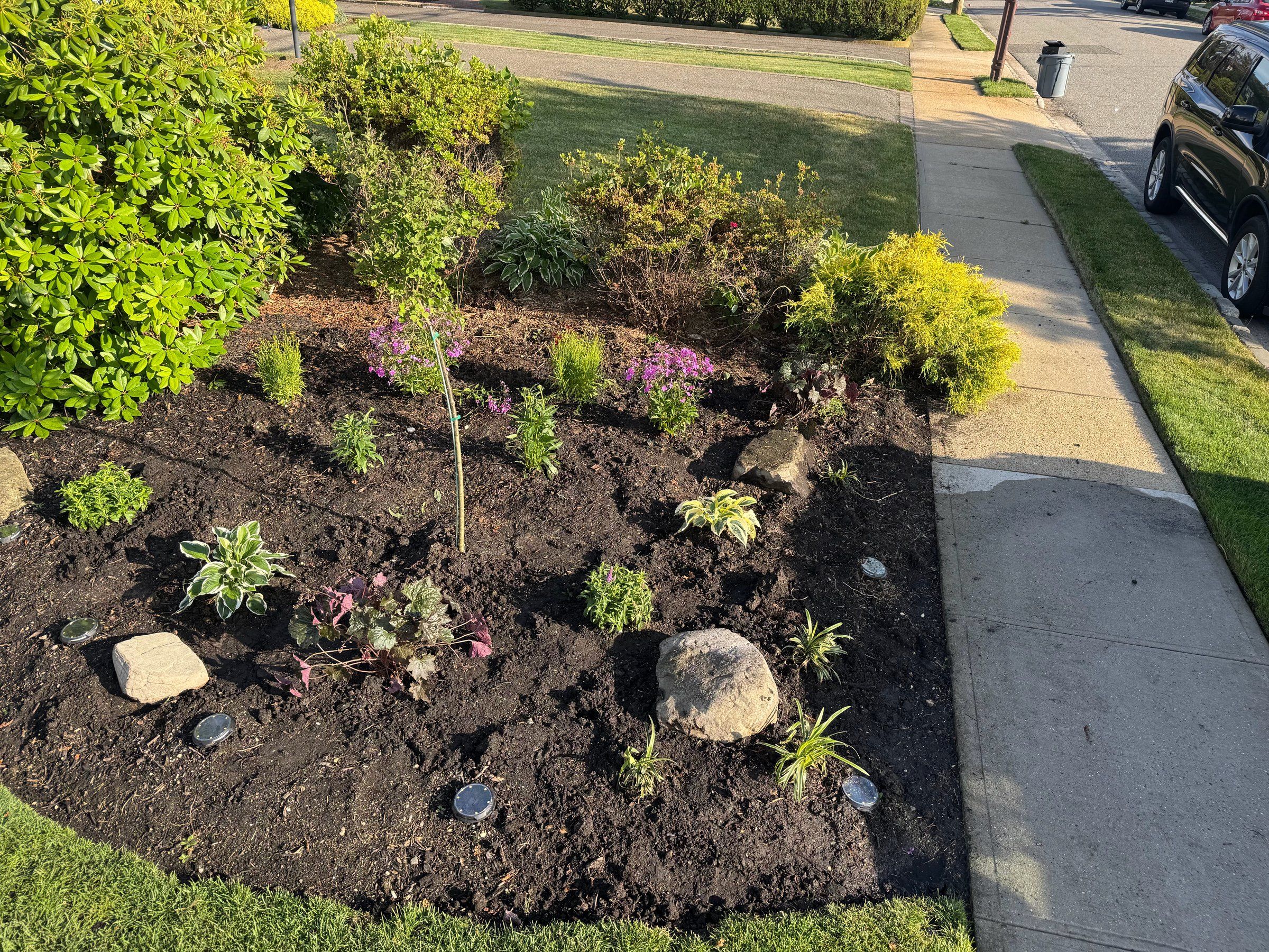 The finished bed beside the sidewalk